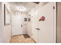 Inviting entryway featuring neutral paint, tile flooring, a coat closet, and white doors at 7222 W Maryland Ave, Glendale, AZ 85303