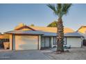 Single-story home featuring an attached garage, low maintenance desert front yard, and a mature palm tree at 7222 W Maryland Ave, Glendale, AZ 85303