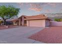 Charming single-story home with a spacious driveway and a well-manicured desert landscape at 7833 S Kenneth Pl, Tempe, AZ 85284
