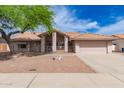 Charming single-story home featuring a well-maintained front yard and two-car garage at 7833 S Kenneth Pl, Tempe, AZ 85284