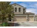 Inviting home featuring a three-car garage, neutral tones, and desert-friendly landscaping at 887 W Santa Gertrudis Trl, San Tan Valley, AZ 85143