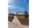 Community park offers a shaded picnic area, playground equipment, and lush green space for outdoor enjoyment at 9137 W Sells Dr, Phoenix, AZ 85037
