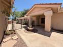 Welcoming front porch with decorative fountain, enclosed by an iron gate and leading to the front door at 1020 W Sunward Dr, Gilbert, AZ 85233