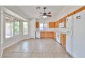Eat-in kitchen with white appliances, wood cabinets, and large windows overlooking the backyard at 11626 W Holly St, Avondale, AZ 85392