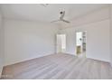 Spacious main bedroom with neutral carpet, walk-in closet and ensuite bathroom entrance at 11626 W Holly St, Avondale, AZ 85392