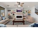Spacious living room with built-in bookshelves, a fireplace, and comfortable seating at 12110 W Rowel Rd, Peoria, AZ 85383