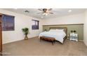 Comfortable bedroom with a plush bed, natural light, and neutral decor at 12110 W Rowel Rd, Peoria, AZ 85383