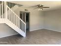 Bright living room with staircase, light-colored tile floors, and a ceiling fan at 2155 W Farmdale Ave # 8, Mesa, AZ 85202