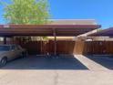 Covered parking area with brown posts and beams offering shaded spots at 2155 W Farmdale Ave # 8, Mesa, AZ 85202