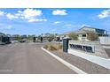 View of gated entry into Coldwater community with attractive landscaping on a sunny day in this desirable neighborhood at 2324 E Marguerite Ave, Phoenix, AZ 85040