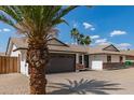 Attractive single-story home with desert landscaping, complemented by a two-car garage and shade trees at 2348 E Diamond Ave, Mesa, AZ 85204