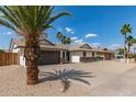Attractive single-story home with desert landscaping, complemented by a two-car garage and shade trees at 2348 E Diamond Ave, Mesa, AZ 85204