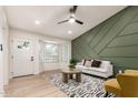 Bright living room featuring a trendy accent wall, recessed lighting, and a new ceiling fan at 2348 E Diamond Ave, Mesa, AZ 85204