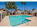 Community pool with lounge area surrounded by well-maintained landscaping at 2455 E Broadway Rd # 115, Mesa, AZ 85204