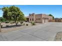 Spacious driveway leading to a well-maintained home with mature trees at 24615 S 182Nd Pl, Gilbert, AZ 85298