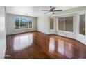Spacious living room with hardwood floors and large windows allowing natural light at 31670 N Desert Willow Rd, San Tan Valley, AZ 85143