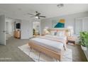 Serene main bedroom includes a ceiling fan, neutral color palette and ample space at 31670 N Desert Willow Rd, San Tan Valley, AZ 85143