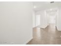 Bright hallway with tile flooring leading to various rooms at 3557 E Audrey Dr, San Tan Valley, AZ 85143