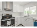 Close-up of a well-lit kitchen showcasing stainless steel appliances, quartz countertops, and white cabinetry at 4307 E Walatowa St, Phoenix, AZ 85044