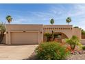 Single-story home with desert landscaping, archway entrance, and an attached two-car garage at 4527 E Sunrise Dr, Phoenix, AZ 85044