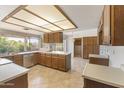Well-lit kitchen boasts ample counter space, stainless steel appliances, and a large garden view window at 4535 E Redfield Rd, Phoenix, AZ 85032