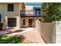 Inviting home featuring a private balcony, desert landscaping, and a charming architectural style at 4812 E Winston Dr # 2, Phoenix, AZ 85044