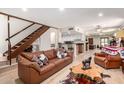 Cozy living room with a rustic staircase, comfortable seating, and an open-concept design to the kitchen at 4812 E Winston Dr # 2, Phoenix, AZ 85044