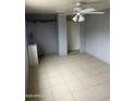 Bedroom featuring tile flooring, ceiling fan, and closet at 527 S Macdonald --, Mesa, AZ 85210