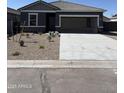 Exterior shot of a single-story house with stone accents and a two-car garage at 5741 E Iris Dr, Florence, AZ 85132