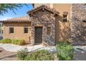 Charming front door with stone accents and manicured landscaping creating a welcoming entrance at 6145 E Cave Creek Rd # 203, Cave Creek, AZ 85331