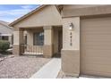 Home exterior featuring a covered porch and two-car garage, with clean lines at 6410 W Winslow Ave, Phoenix, AZ 85043
