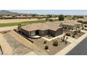 Charming desert landscaping surrounds a well-maintained property with a view of the local golf course at 6811 S Four Peaks Way, Chandler, AZ 85249