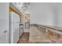 Bright kitchen with white appliances, wood cabinets, sink, and wood look vinyl floors at 827 E Pecan Rd, Phoenix, AZ 85040