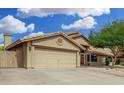 Single-Gathering home with a large two-car garage, desert landscaping, and a charming front entrance at 9004 S Ash Ave, Tempe, AZ 85284