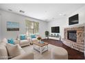 Bright living room with a stone fireplace and sleek hardwood floors for a modern feel at 970 S Henry Ln, Gilbert, AZ 85296