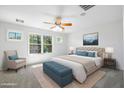 Inviting bedroom with a large window providing ample natural light and a ceiling fan at 970 S Henry Ln, Gilbert, AZ 85296
