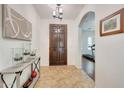 Inviting foyer features a stylish console table, elegant lighting, and an arched entryway leading to other rooms at 9845 E Edgestone Dr, Scottsdale, AZ 85255