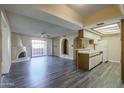Open-concept layout featuring a kitchen, fireplace, and sliding glass door to the outside at 10410 N Cave Creek Rd # 2220, Phoenix, AZ 85020