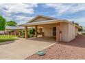 Single story home with a covered carport and a well-maintained concrete driveway at 10724 W Cheryl Dr, Sun City, AZ 85351