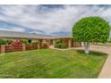 Well-maintained lawn and charming brick and wood fence at 10724 W Cheryl Dr, Sun City, AZ 85351