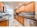 Spacious kitchen with stainless steel appliances and stylish countertops at 10827 W Santa Fe Dr, Sun City, AZ 85351