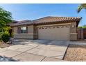 A single-story home features a desert landscape and a convenient two-car garage at 11402 W Hadley St, Avondale, AZ 85323