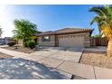 Single-story house featuring a tile roof, desert landscaping, and a spacious two-car garage at 11402 W Hadley St, Avondale, AZ 85323
