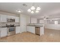 Well-appointed kitchen boasts granite countertops, stainless steel appliances, and white cabinetry at 11538 W Windrose Ave, El Mirage, AZ 85335