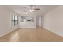 Bright, open living area features neutral paint, tile flooring, and ample natural light at 11538 W Windrose Ave, El Mirage, AZ 85335