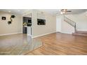Spacious living area with tile and hardwood floors with a kitchen pass-through and open staircase at 1342 W Emerald Ave # 286, Mesa, AZ 85202