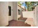 Enclosed patio featuring a brick-paved surface, providing a private outdoor space with views of the home's exterior at 1342 W Emerald Ave # 286, Mesa, AZ 85202