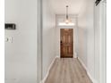 Entryway with wood floors, a pendant light, and views to the front door at 1653 E Gail Dr, Chandler, AZ 85225