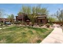 Beautiful landscaping surrounds the exterior of this lovely multi-story house at 17665 N 93Rd Way, Scottsdale, AZ 85255