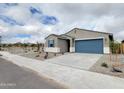 Single-story home featuring a blue garage door, blue shutters and drought tolerant rock landscaping at 19390 N Fiano Dr, Maricopa, AZ 85138
